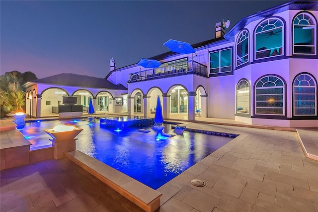 view of pool featuring a patio and a hot tub