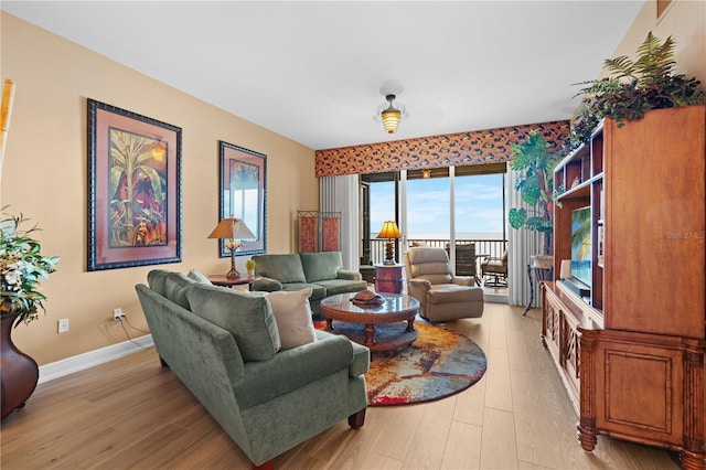 living room featuring light wood-style floors and baseboards