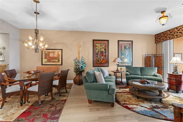 living area featuring light wood-type flooring and an inviting chandelier