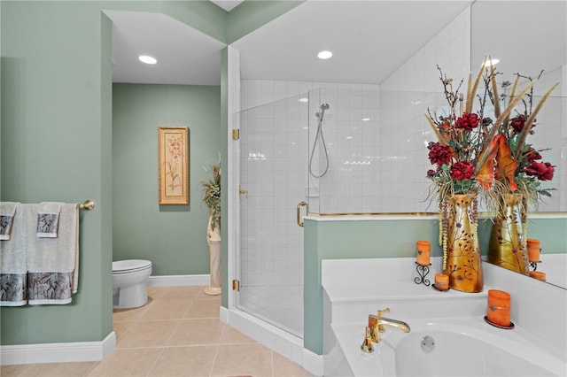 full bathroom featuring tile patterned floors, toilet, a stall shower, baseboards, and a bath