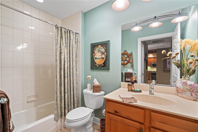 full bath featuring vanity, shower / bath combo with shower curtain, and toilet