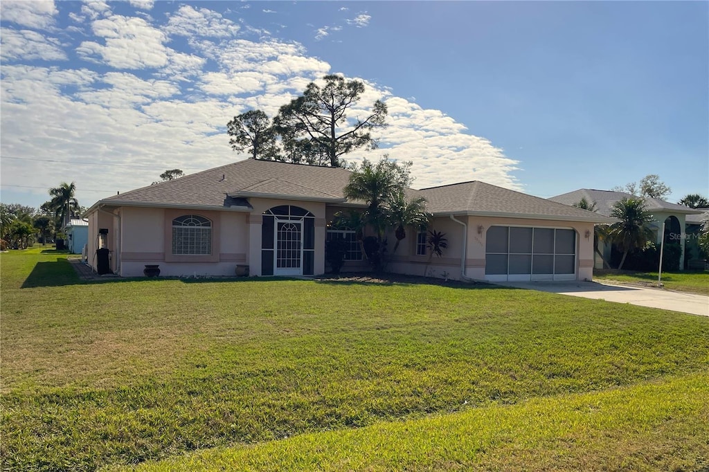 ranch-style home with a garage and a front yard