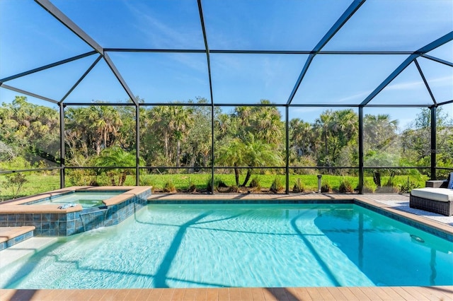 view of swimming pool featuring glass enclosure and a pool with connected hot tub