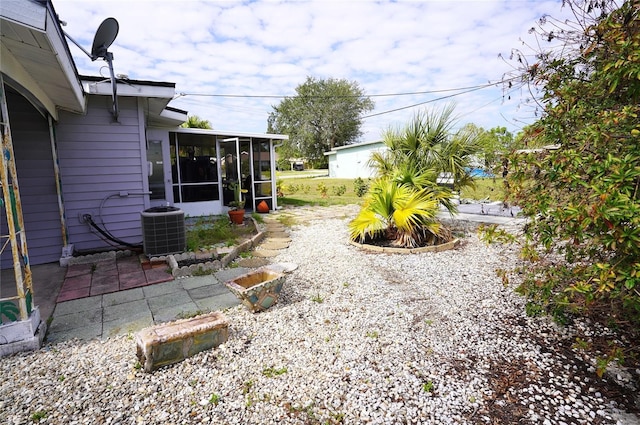 view of yard featuring cooling unit and a sunroom