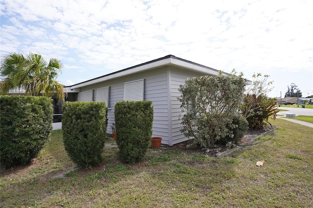 view of side of property with a yard