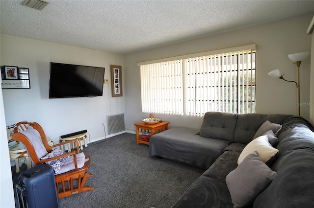 carpeted living room featuring a textured ceiling