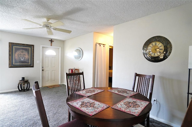 dining room featuring carpet flooring, a textured ceiling, and ceiling fan