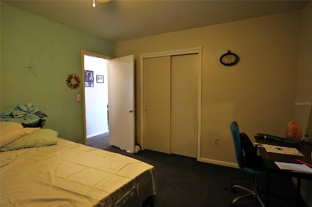 bedroom featuring dark carpet and a closet