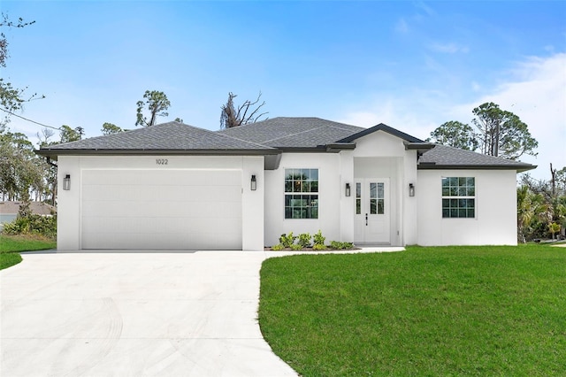 view of front of house featuring an attached garage, driveway, roof with shingles, stucco siding, and a front lawn