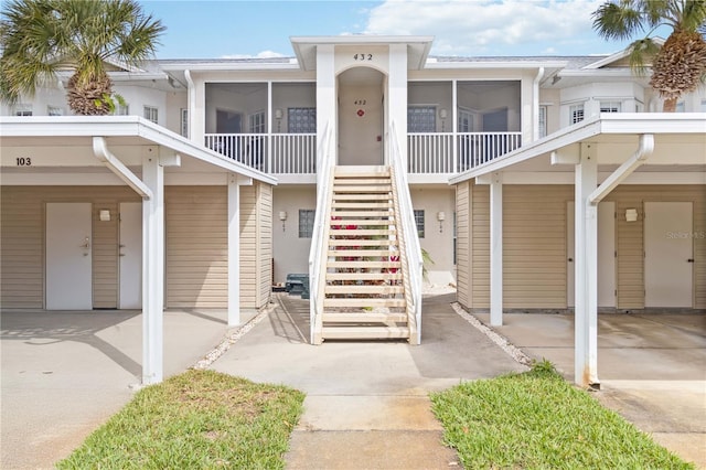 view of front of house featuring a sunroom and stairs