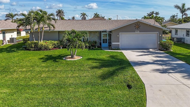 single story home featuring a garage, central air condition unit, and a front yard