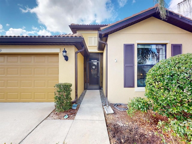 doorway to property with a garage