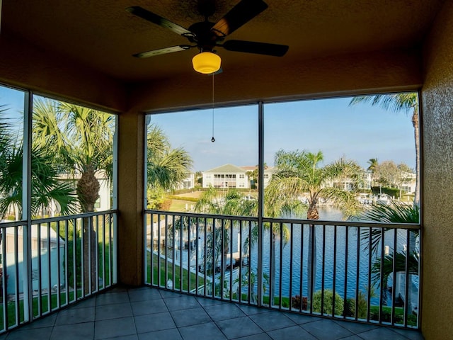unfurnished sunroom featuring a water view