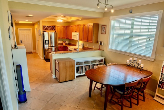 kitchen featuring stove, stainless steel refrigerator with ice dispenser, ornamental molding, decorative light fixtures, and kitchen peninsula