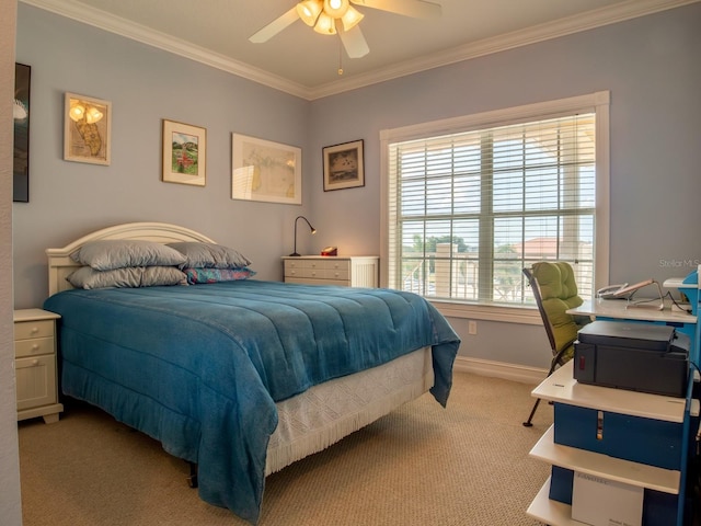carpeted bedroom featuring crown molding and ceiling fan