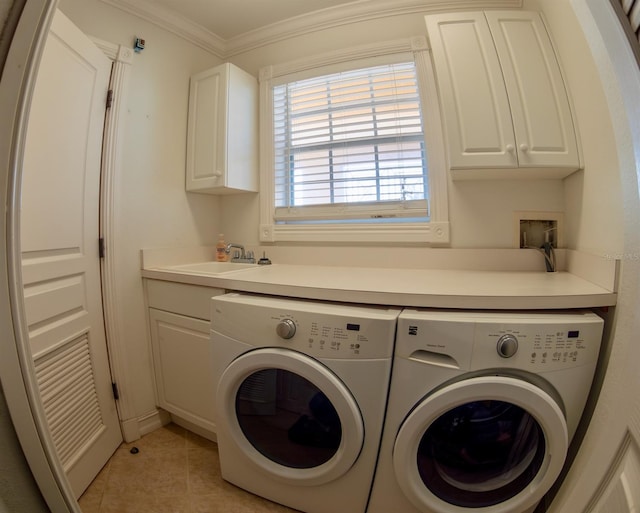 washroom featuring sink, cabinets, ornamental molding, light tile patterned floors, and washing machine and dryer