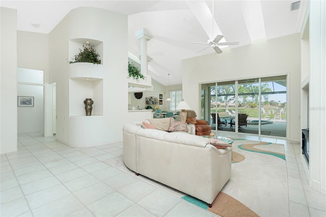 tiled living room featuring ceiling fan, plenty of natural light, and high vaulted ceiling