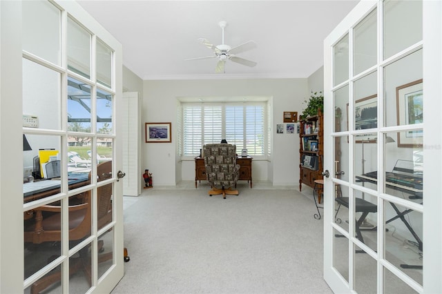 carpeted home office with crown molding, ceiling fan, and french doors