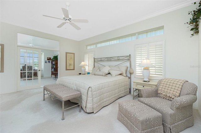 bedroom with multiple windows, crown molding, light colored carpet, and ceiling fan