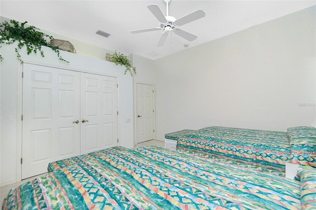 bedroom with ceiling fan and a closet