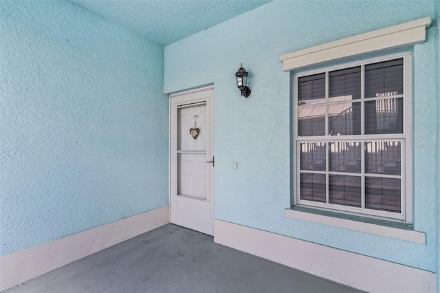 doorway to property with stucco siding