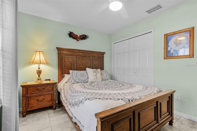 bedroom featuring light tile patterned floors, visible vents, a closet, and ceiling fan