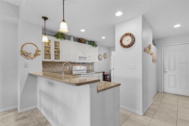 kitchen featuring tasteful backsplash, glass insert cabinets, stone countertops, white appliances, and white cabinetry