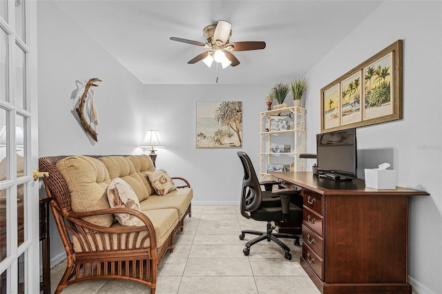 home office with light tile patterned flooring, baseboards, and ceiling fan