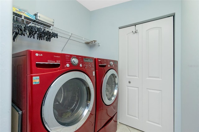 washroom featuring light tile patterned flooring and washer and dryer