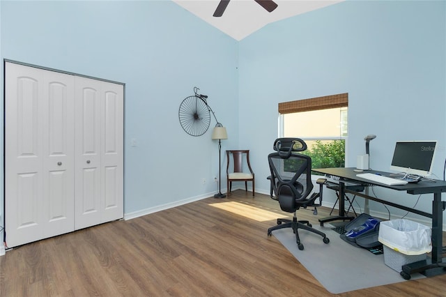 office space featuring high vaulted ceiling, hardwood / wood-style floors, and ceiling fan