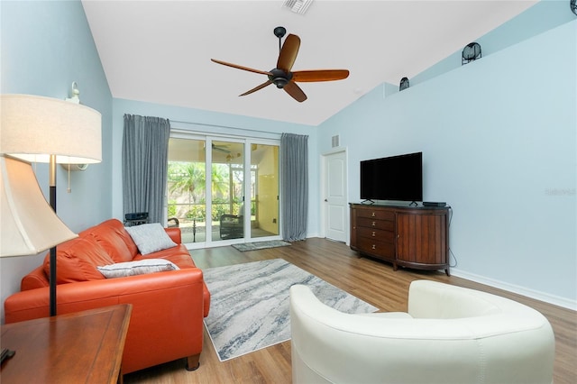 living room with ceiling fan, wood-type flooring, and lofted ceiling