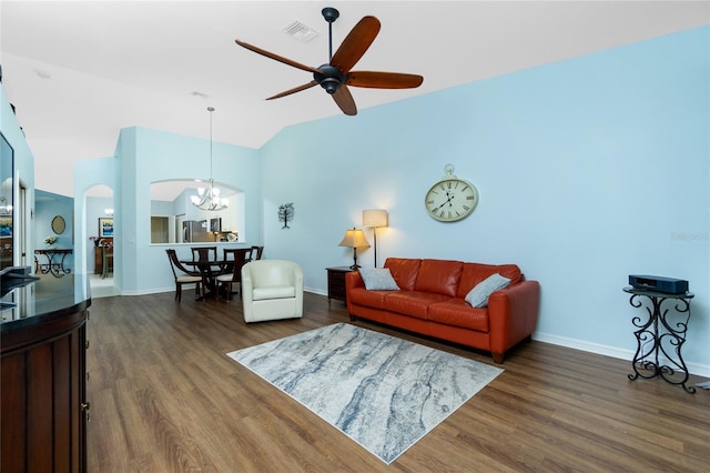 living room featuring ceiling fan with notable chandelier, lofted ceiling, and dark hardwood / wood-style flooring