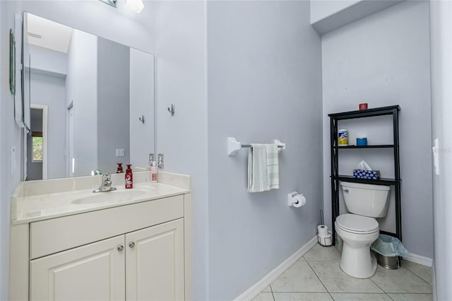 bathroom with vanity, toilet, and tile patterned floors