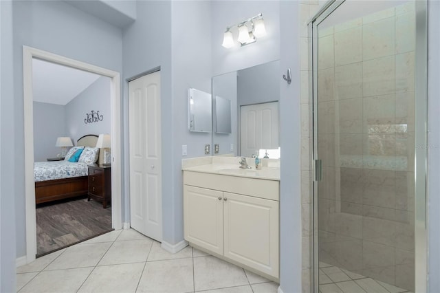 bathroom featuring vanity, tile patterned flooring, and a shower with door