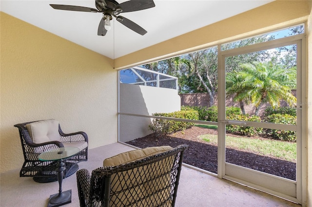 sunroom featuring ceiling fan