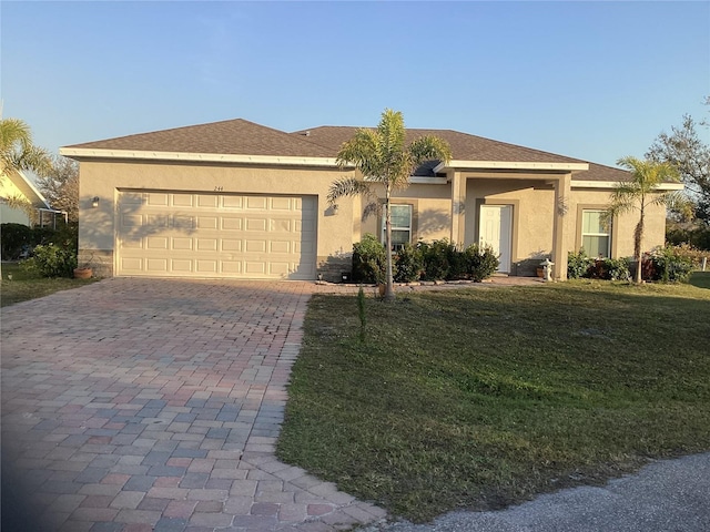 single story home with a garage and a front yard