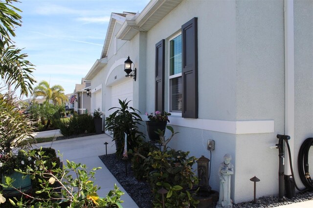 24313 Westgate Blvd, Punta Gorda, FL 33980 - view of side of home with stucco siding and a garage