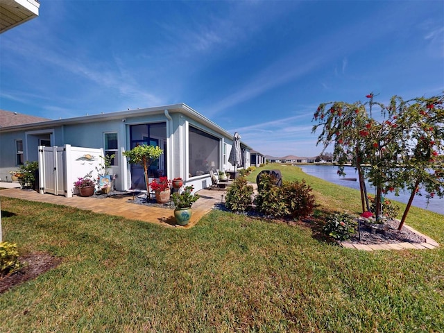 24313 Westgate Blvd, Punta Gorda, FL 33980 - back of property featuring a lawn, a sunroom, and a water view