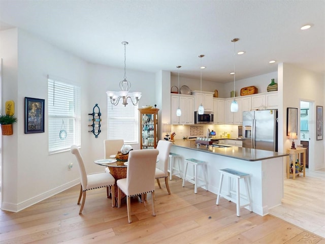 24313 Westgate Blvd, Punta Gorda, FL 33980 - dining area featuring light wood-type flooring, a chandelier, recessed lighting, and baseboards