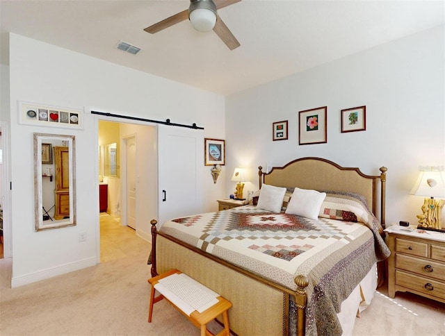 24313 Westgate Blvd, Punta Gorda, FL 33980 - bedroom featuring a barn door, light carpet, baseboards, a ceiling fan, and ensuite bath