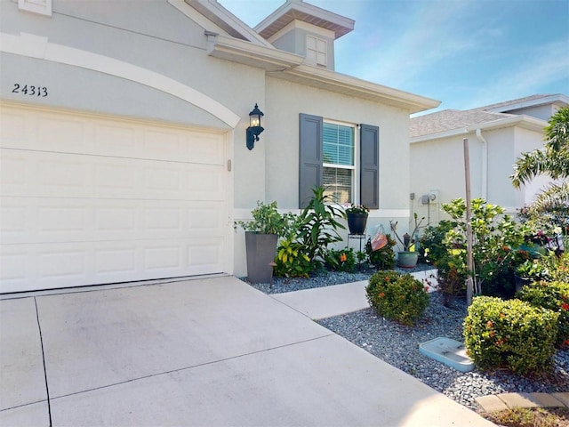24313 Westgate Blvd, Punta Gorda, FL 33980 - doorway to property with stucco siding and driveway