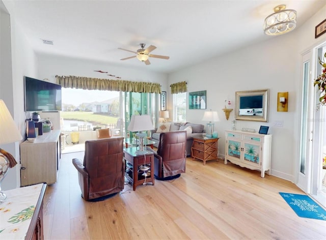 24313 Westgate Blvd, Punta Gorda, FL 33980 - living room featuring wood finished floors, ceiling fan, and baseboards