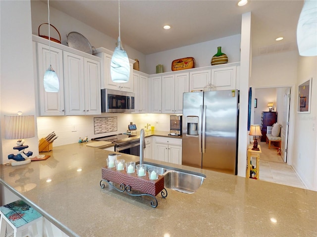 24313 Westgate Blvd, Punta Gorda, FL 33980 - kitchen with stainless steel appliances, tasteful backsplash, white cabinets, and recessed lighting