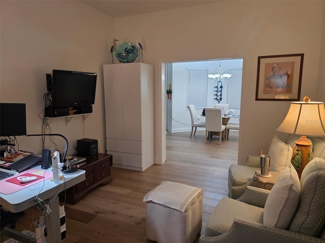 24313 Westgate Blvd, Punta Gorda, FL 33980 - living room featuring light wood finished floors and a chandelier
