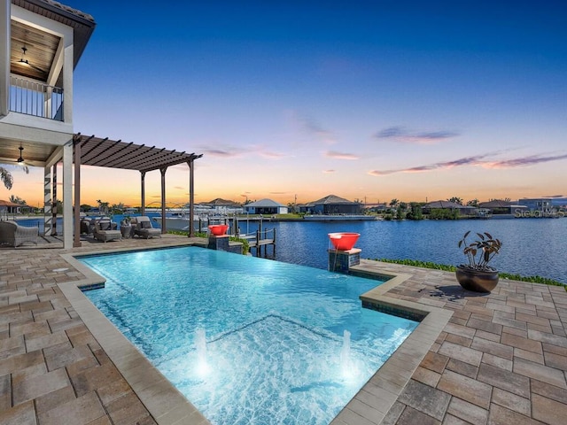 pool at dusk with a boat dock, ceiling fan, a pergola, a water view, and a patio area