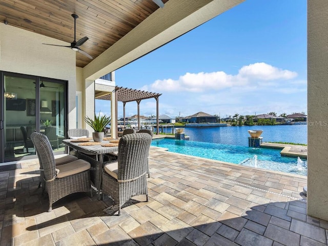 view of swimming pool with a water view, ceiling fan, a patio, and pool water feature