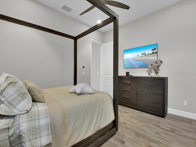 bedroom with ceiling fan and light hardwood / wood-style floors