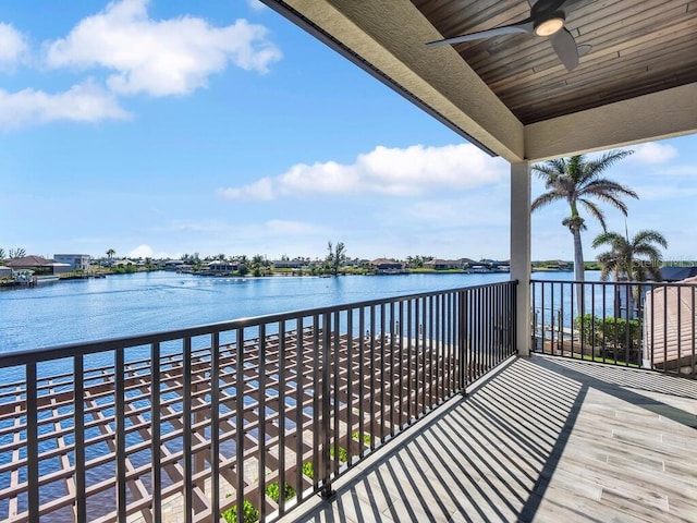 balcony with ceiling fan and a water view