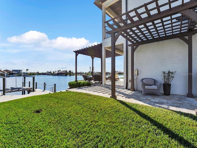 view of yard with a pergola, a dock, a patio area, and a water view