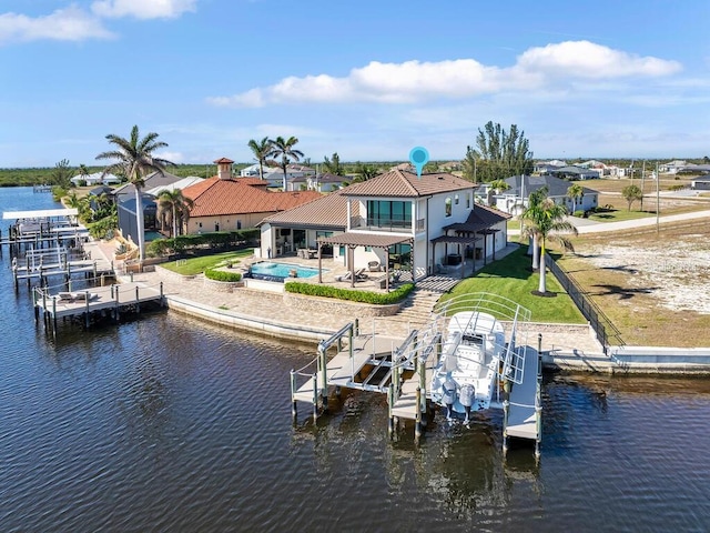 view of dock featuring a water view, a balcony, a patio, and a lawn